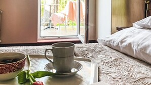 A tray with a mug and a bowl on a bed with a patterned bedspread. - Beautiful apartment in Pobierowo with WiFi (Pobierowo)