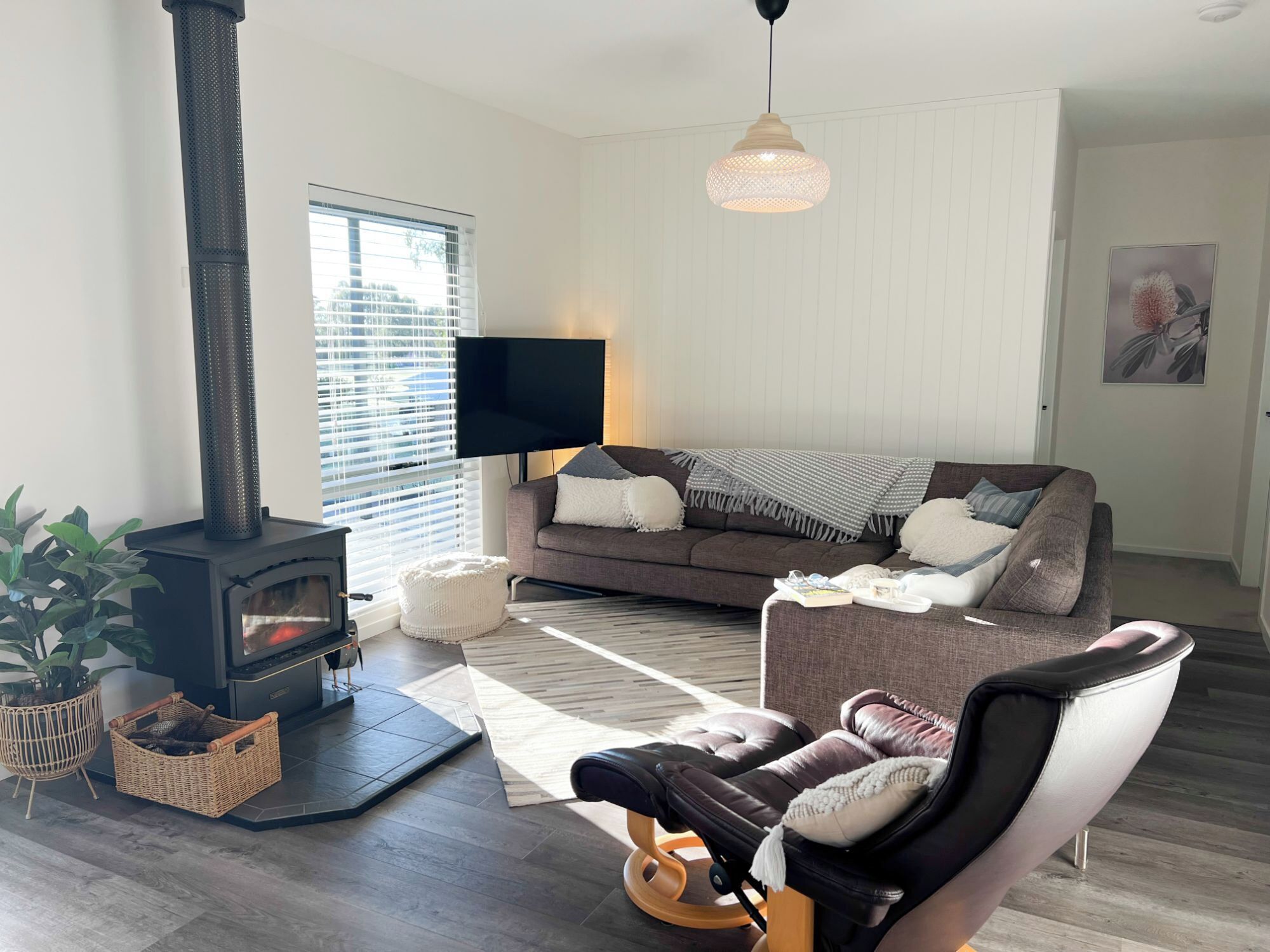 Cosy up by the roaring wood fire in our sunlit, open-plan living area.