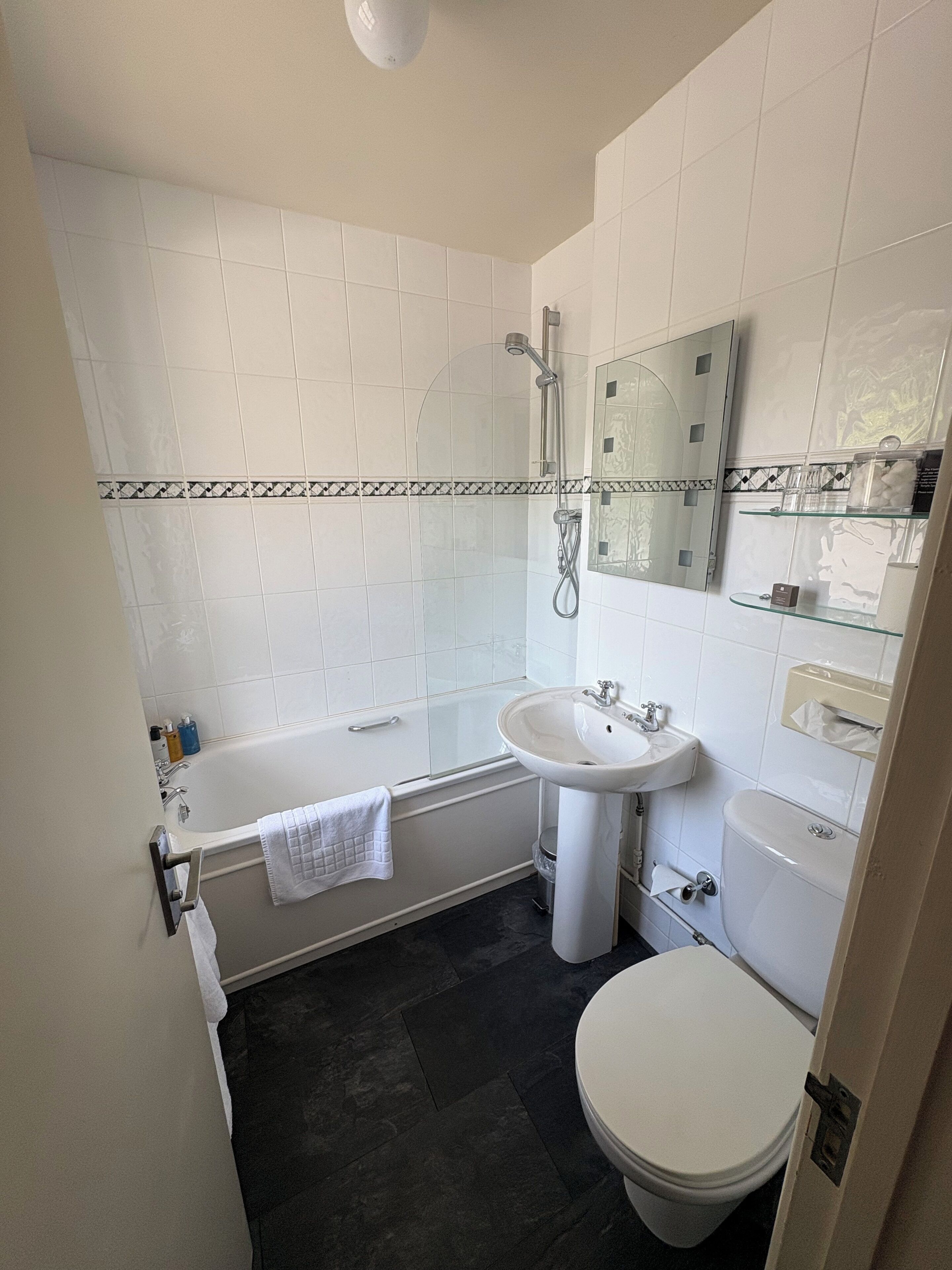 A bathroom with a bathtub, a sink, a toilet, and a shower.