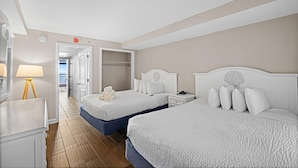 A hotel room with two beds, a nightstand, a lamp, and a view of the outside. - Roomy Oceanfront Ste Includes Breakfast 15th Flr (Myrtle Beach)
