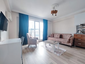 Standard Condo, Balcony | Living area | TV