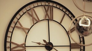 A large wall clock with Roman numerals and a minimalist design. - DORIAN GRAY LUXURY SUITE (Trieste)
