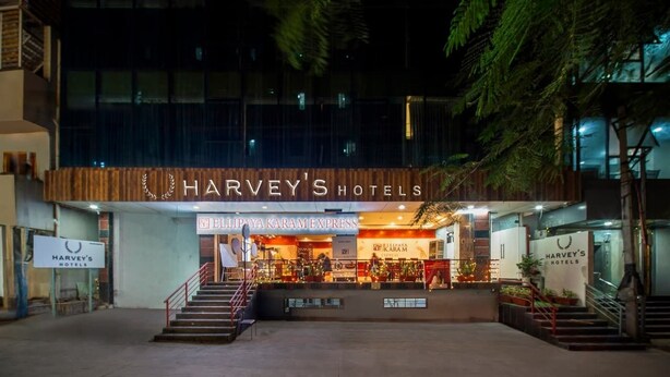 Entrada de un hotel con un letrero que dice 'Harvey's Hotels' y una puerta visible.