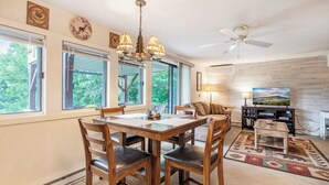 A dining area with a wooden table and chairs, a chandelier, and a ceiling fan. - Top of 7, B-10- Close to Boone & Banner Elk, Mtn View, Fireplace, Cute & quaint (Seven Devils)