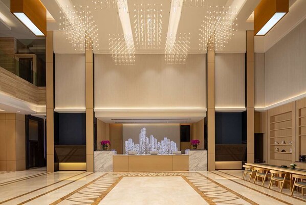 A spacious lobby with a reception desk, modern chandeliers, and a cityscape artwork. - Days Hotel BY Wyndham Shenzhen Sanlian (Shenzhen)