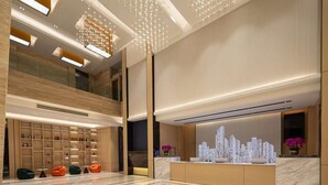 A modern lobby with a reception desk, seating area, and a cityscape light installation. - Days Hotel BY Wyndham Shenzhen Sanlian (Shenzhen)