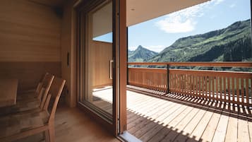 A wooden deck with a view of mountains.