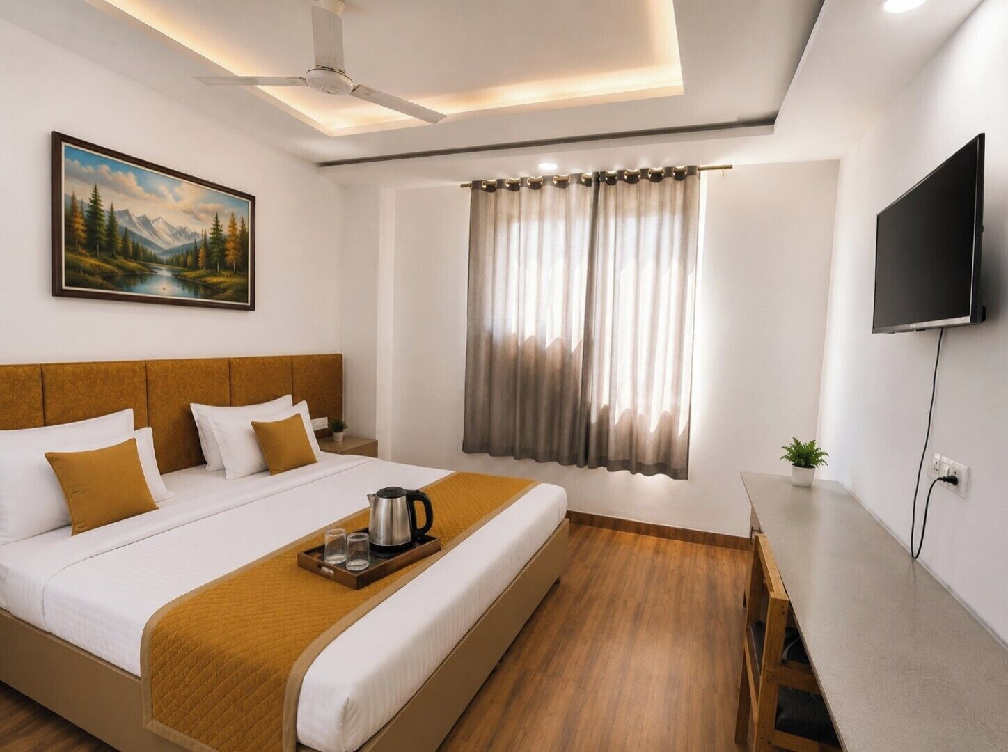 A hotel room with a bed, a painting, a ceiling fan, a TV, and a window with curtains.