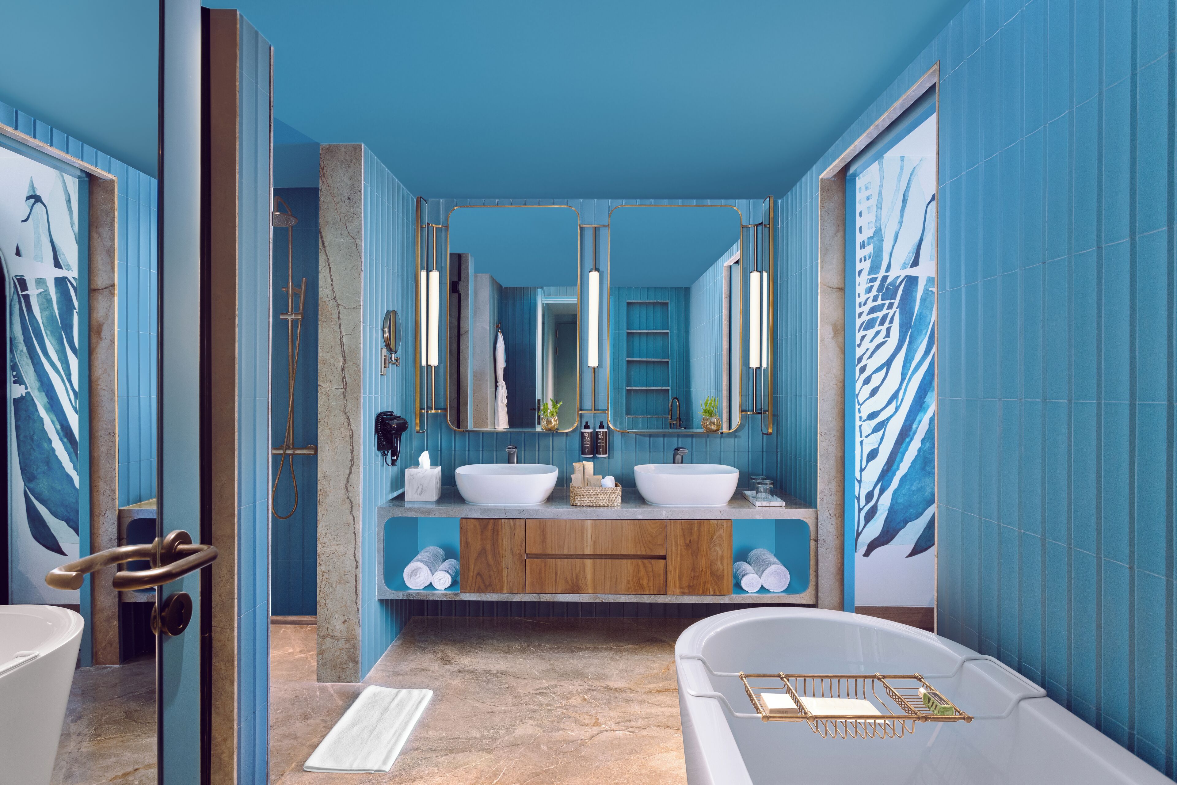 A modern bathroom with two sinks, a bathtub, and a shower.