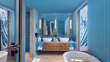 A modern bathroom with two sinks, a bathtub, and a shower.