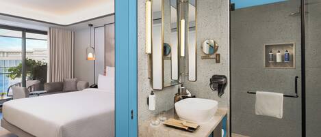 A modern hotel room with a large bed, a bathroom with a large mirror, a sink, and a shower.