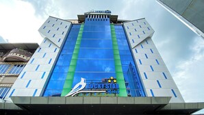 A hotel with a prominent 'Lucky Star Hotel' sign, large glass windows, and a modern architectural design. - Lucky Star Hotel Near Harbour Bay Batam (Batam)