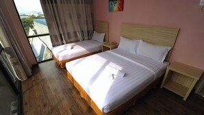 A hotel room with two beds, wooden flooring, a large window with a view, and a painting on the wall. - YP Boutique Hotel, Paradigm Mall Petaling Jaya (Petaling Jaya)