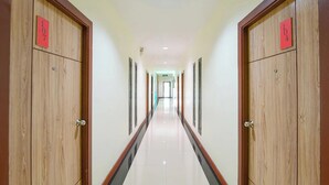 A hallway with wooden doors, each marked with a number. - The Nine Place (Hat Yai)