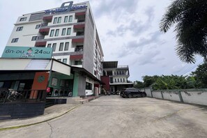 A multi-story building with a sign for 'Lazy Wash' and 'The Nine Place' on the ground floor. - The Nine Place (Hat Yai)