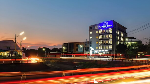 A modern hotel with a prominent 'The Nine Place' sign, multiple floors, and a well-lit facade. - The Nine Place (Hat Yai)
