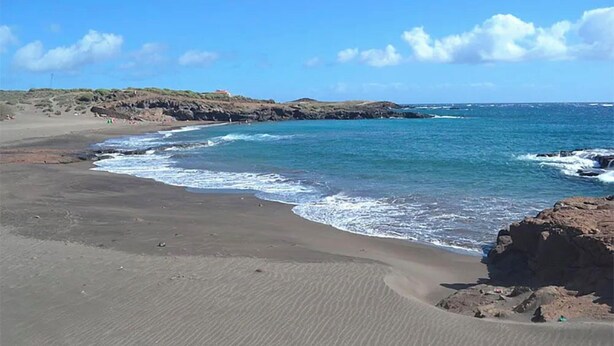 A beach with a rocky shoreline and calm waves. - Abades Beach Houses by EstrellaDelNorte (Arico)