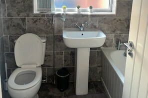 Combined shower/tub, deep soaking tub, towels, toilet paper