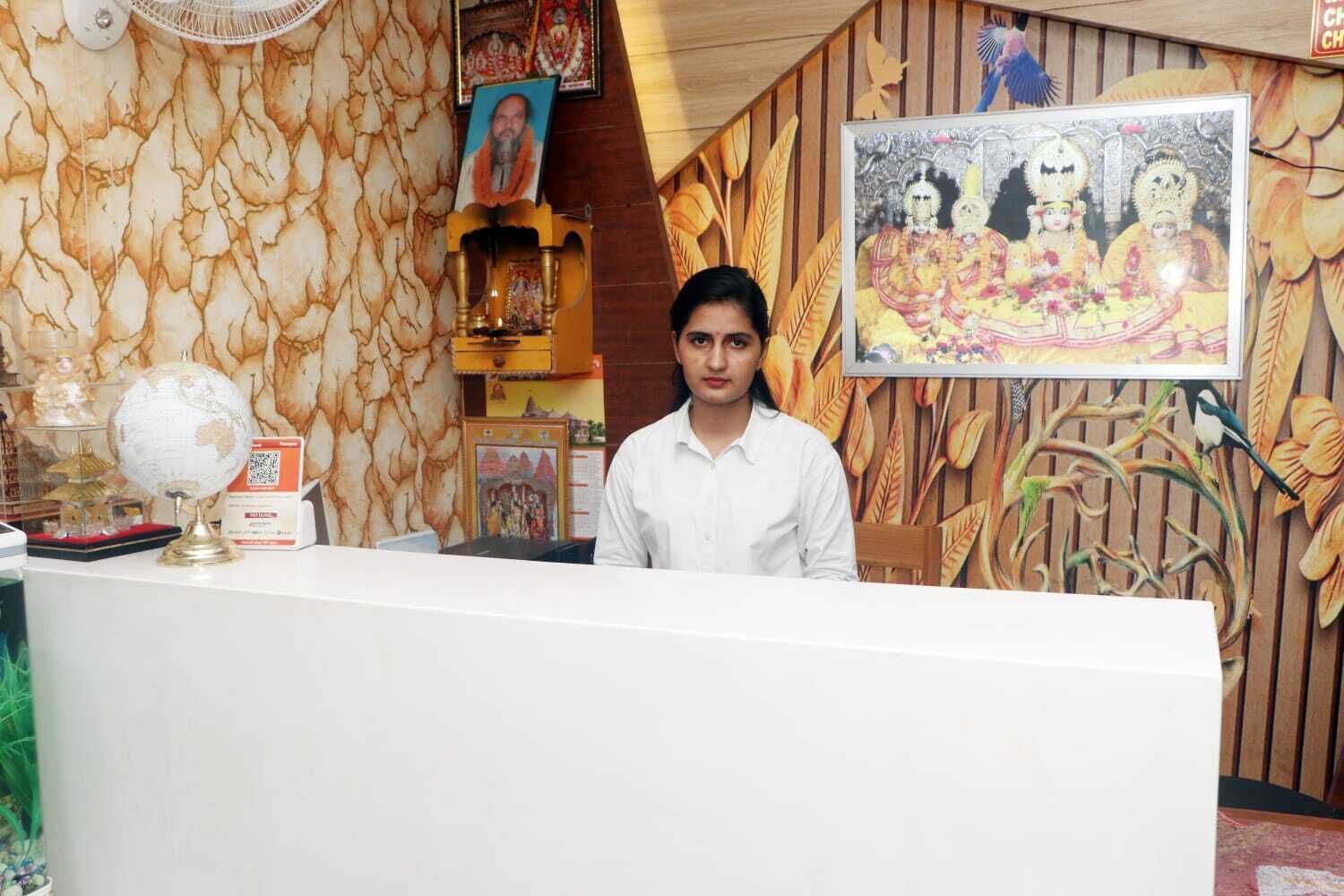 A reception desk with a globe, framed pictures, and a decorative wall.