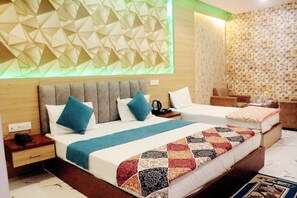 A hotel room with two beds, a modern geometric wall design, and a patterned wallpaper. - RBS Hotel & Restaurant In-Front Ram Temp (Faizabad)