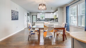 A spacious kitchen with white cabinets, a central island, and pendant lighting. - Private Hot Tub! Pet-friendly Hub By Mercedes-benz (Atlanta)