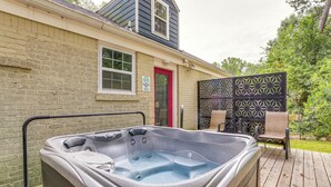 A hot tub on a wooden deck with a brick wall and a red door in the background. - Private Hot Tub! Pet-friendly Hub By Mercedes-benz (Atlanta)