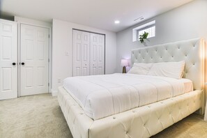 A bedroom with a large bed, a wardrobe, and a small window. - 7 Mi to Baltimore: Maryland Gem w/ Shared Yard! (Baltimore)
