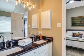 A bathroom with a double sink, a mirror, and a towel rack. - Bryan Home: Close to Campus & Kyle Field (Bryan)