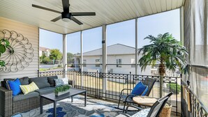 A sunlit balcony with a sofa, chairs, a table, and a ceiling fan. - Condo w/ Pool ~ 2 Mi to Table Rock Lake! (Branson)