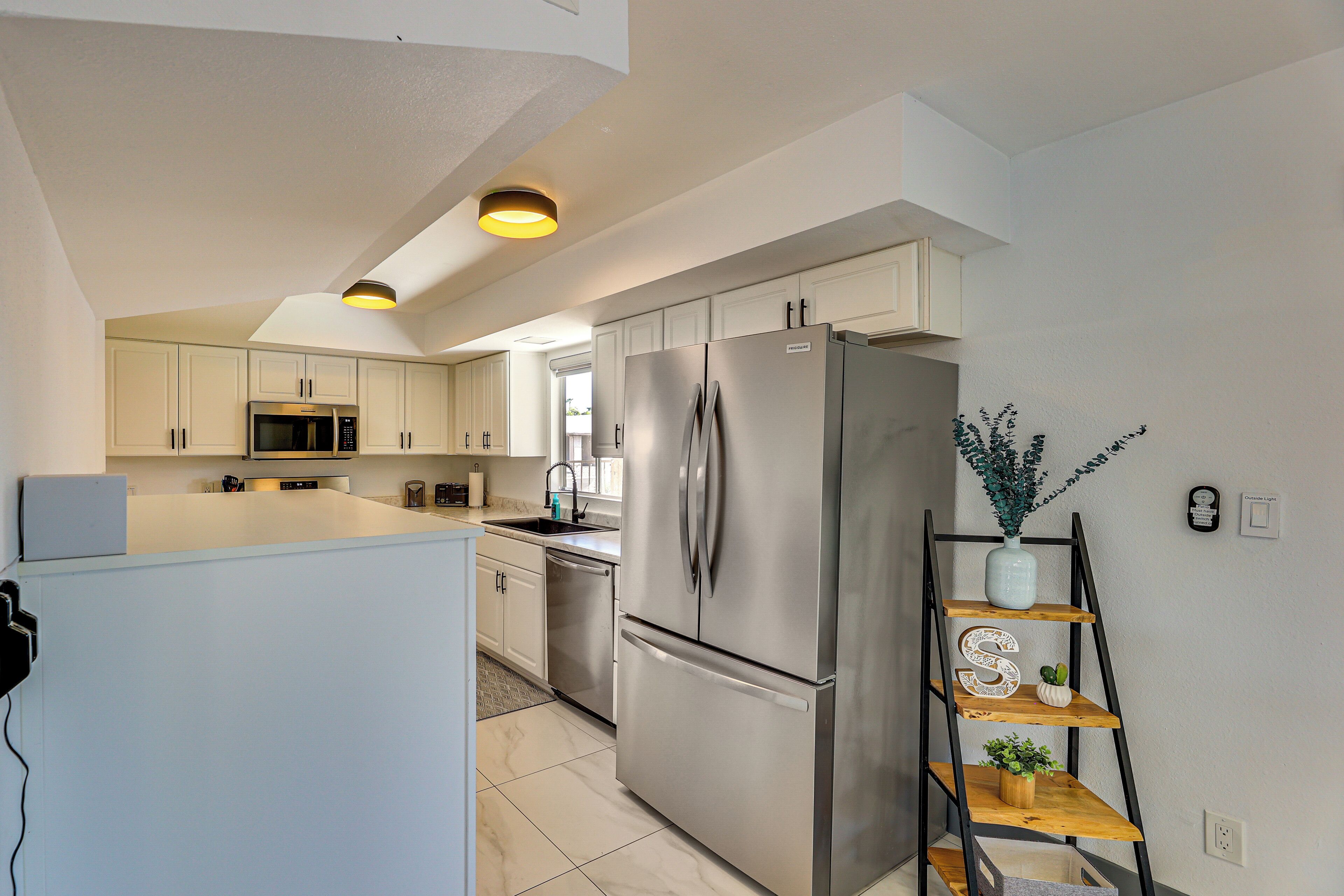 A modern kitchen with stainless steel appliances, a wooden island, and a built-in oven.