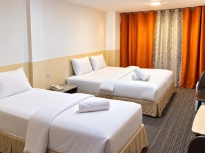 A hotel room with two beds, a desk, and a chair. - Sadaf Hotel (Dubai)