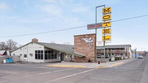A Silver Spur Motel with a prominent sign, a brick building, and a parking lot.