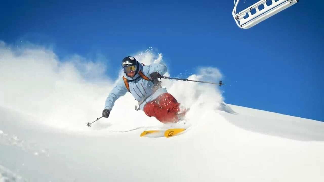 A person skiing down a snowy slope.