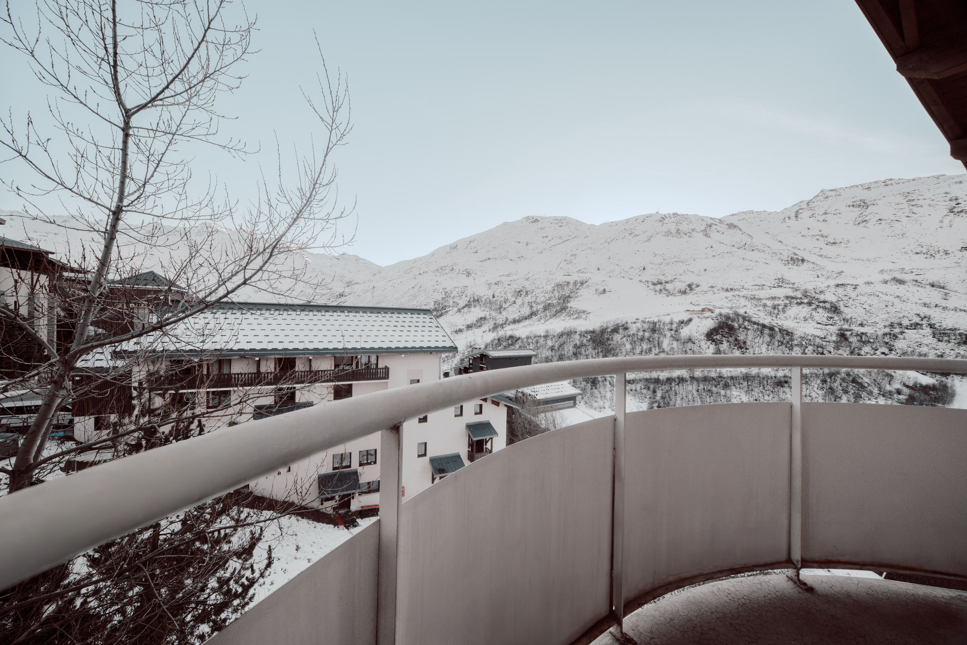 A snow-covered mountain landscape with a traditional building in the background.