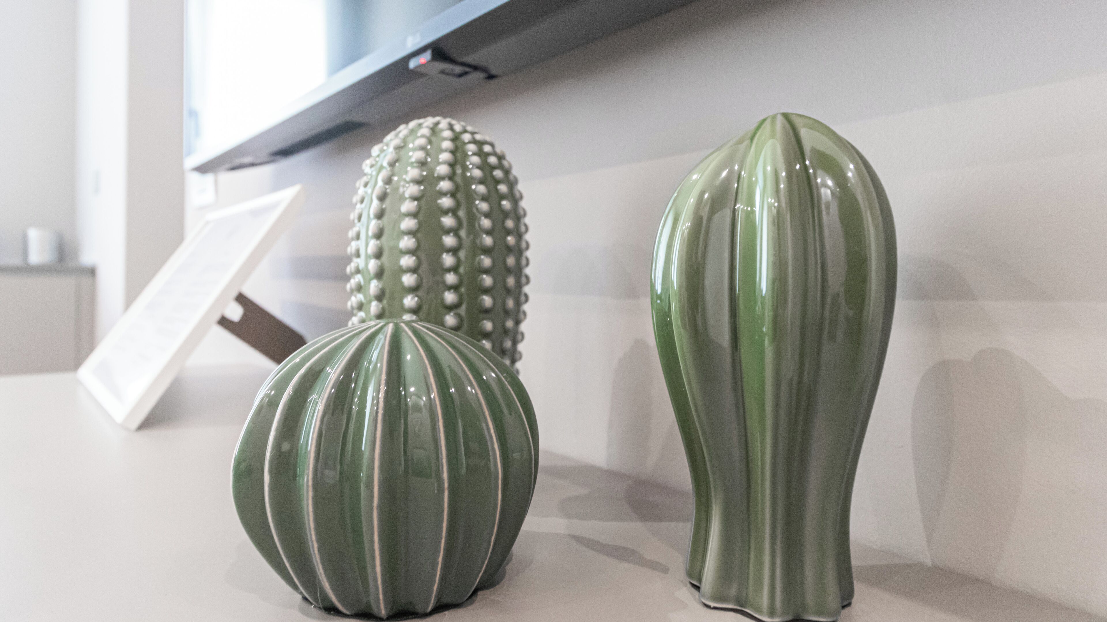 Three ceramic vases on a white surface.