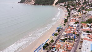 A coastal town with a beach, buildings, and a road. - Pousada Terra do Sol Natal (Natal)