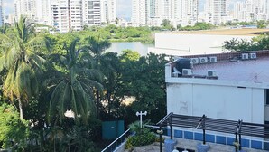 A rooftop pool area with lounge chairs, a view of a city skyline, and palm trees. - Apartment on the 4th floor with beautiful views by Parceros Group (Cartagena)