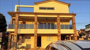 A two-story building with a flat roof and a balcony on the upper floor. - Apartamento 1BED sosua 1minute from airport pop (Puerto Plata)