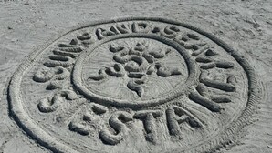 A circular sand art with the words "SUNS AND STARS" and a tree design. - Sunsets over Siesta Key in this cozy 2+2 condo
 (Sarasota)