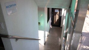 A reception area with a sign indicating it as the reception. - Ocean's Guesthouse - foreigners only (Seoul)