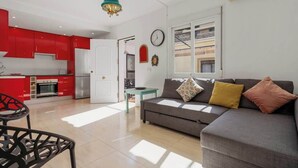 A modern apartment with a kitchen, living area, and a dining table.