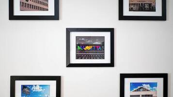 A series of framed photographs of buildings, including a cinema and a train station.