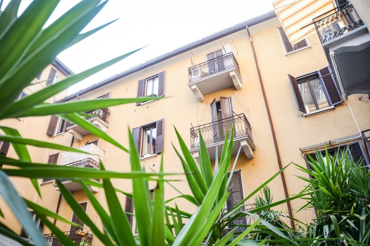 A multi-story building with balconies and windows.
