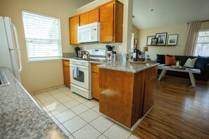 A kitchen with wooden cabinets, a stove, and a microwave. - Mountain Retreat 4 Miles to Park Entrance Walk to Dining (Three Rivers)
