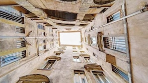 A narrow corridor with multiple windows and doors, leading to a central open space. - Superb studio with balcony city center Opera (Lyon)
