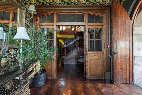 A wooden staircase with a handrail, leading to a second floor.
