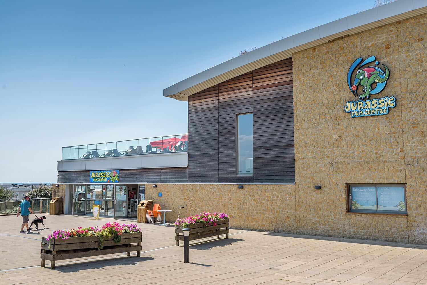A modern building with a sign for 'Jurassic Fun Centre'.