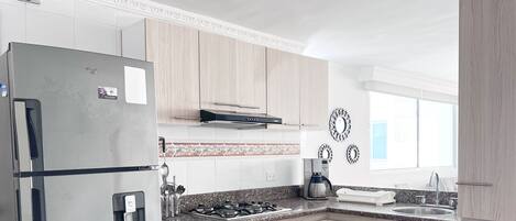 Fridge, oven, coffee/tea maker, cookware/dishes/utensils