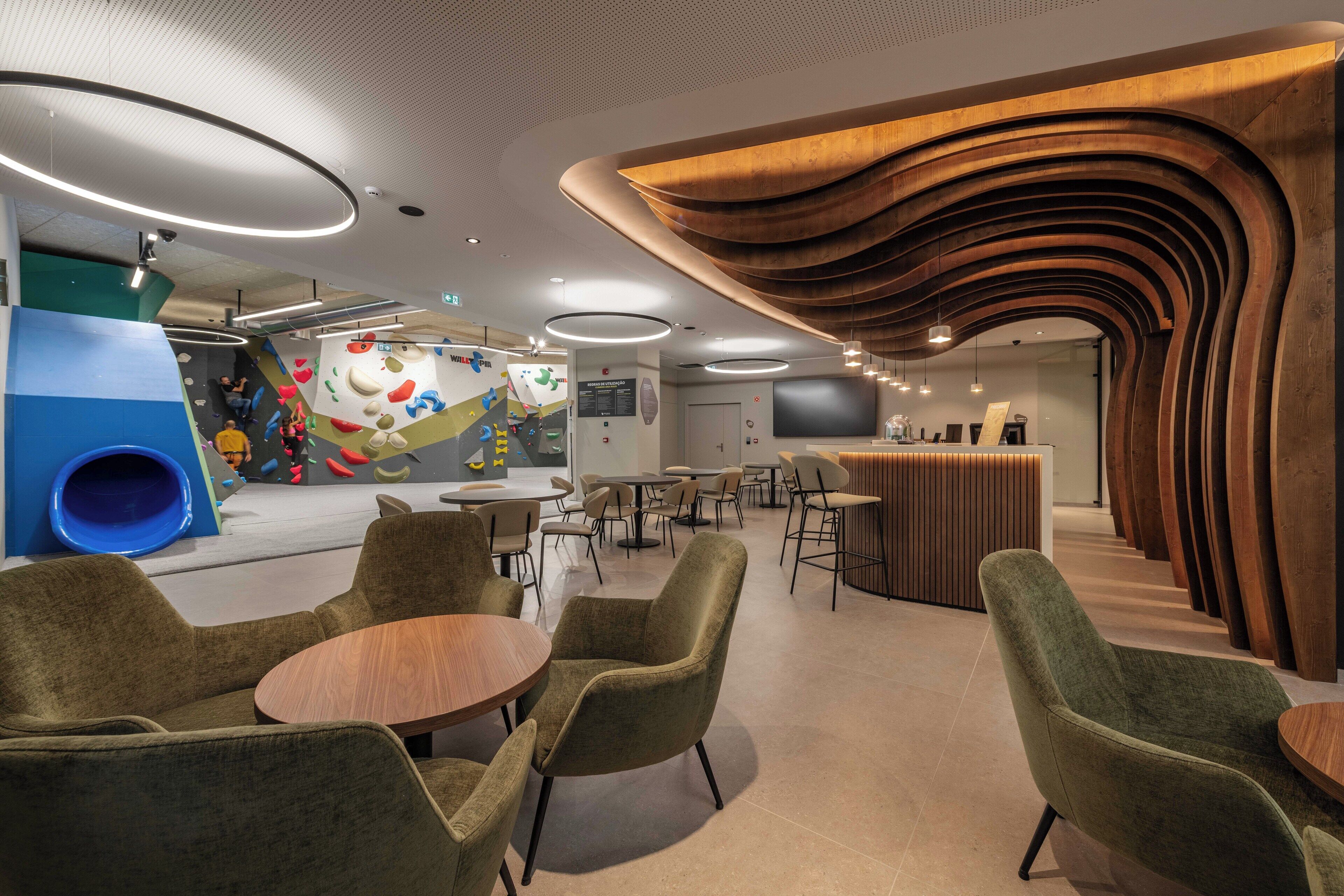 A modern indoor space with a play area, seating, and a counter.