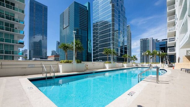 A rooftop pool with a view of high-rise buildings. - The Club 1606 · Impressive Unit in the heart of Brickell W Parking (Miami)